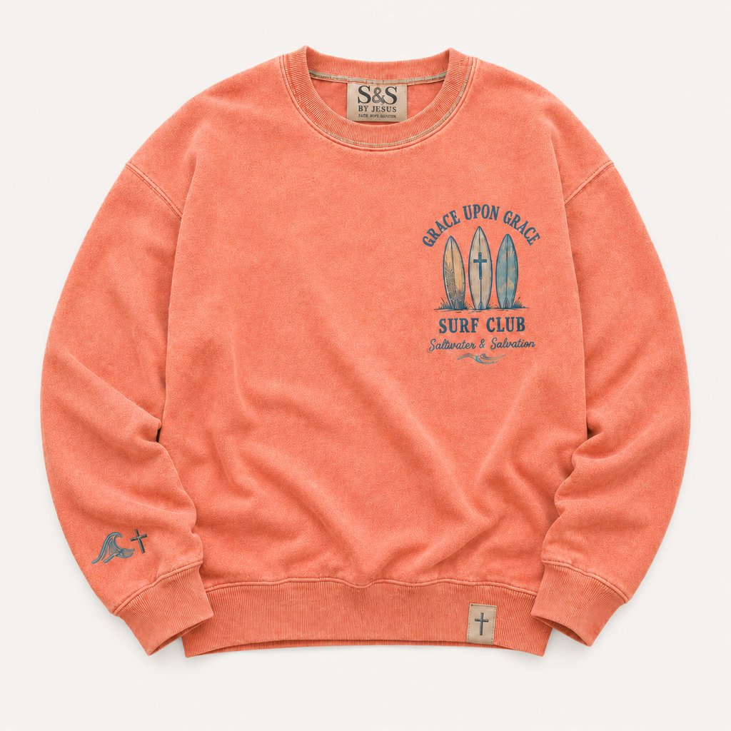 Coral crewneck with graphic design and branding on a white background