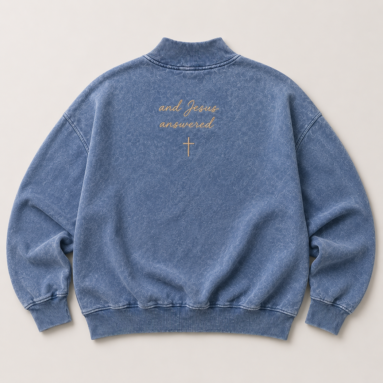 Blue sweatshirt with and Jesus answered text and cross on a light gray background