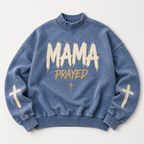 Blue sweatshirt with 'MAMA PRAYED' text and cross designs on a light gray background