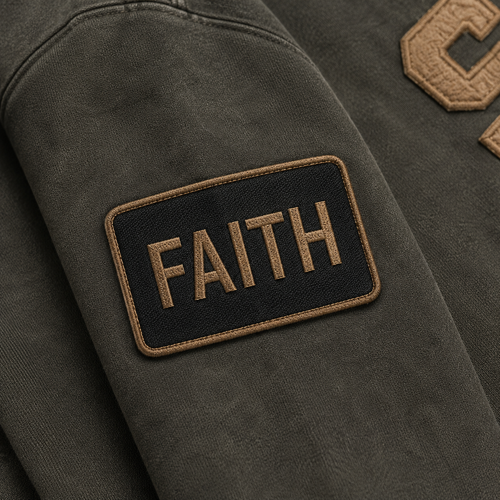 Patch with the word 'FAITH' on a dark fabric background