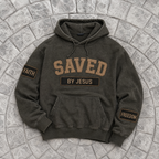 Dark green/black hoodie with 'SAVED BY JESUS' text on a stone surface