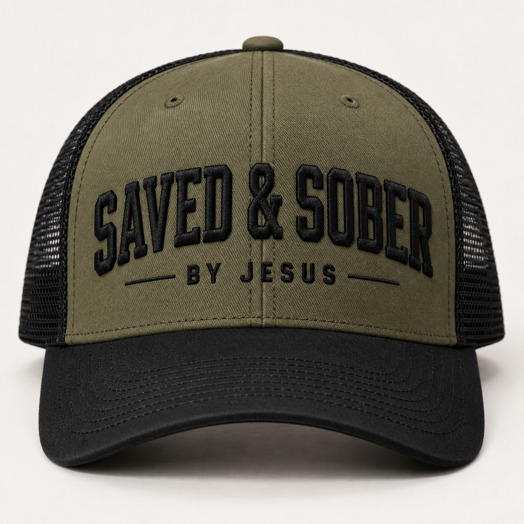 Olive and black trucker hat with embroidered SAVED & SOBER BY JESUS lettering